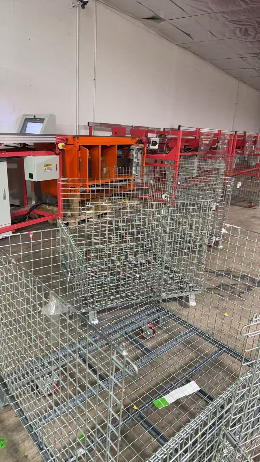 Sort modules with roll cages staged alongside the line during installation